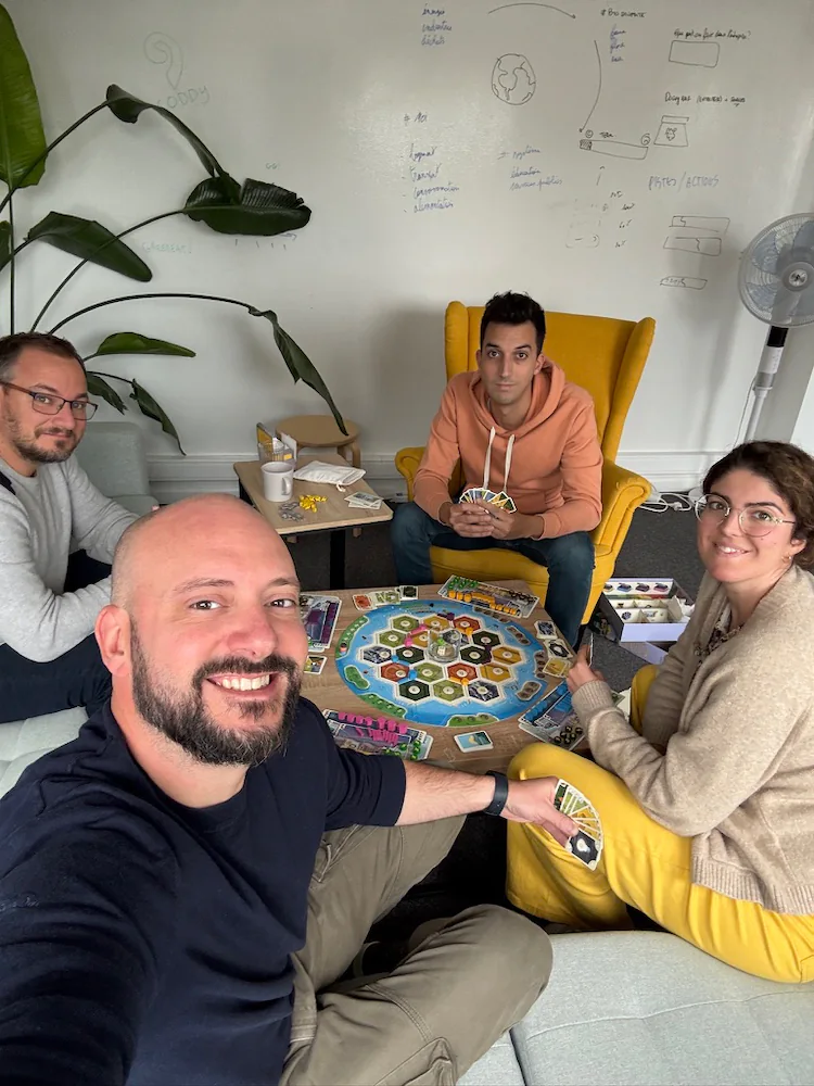 Part of the Coddy team around a board game in the Brussels office.