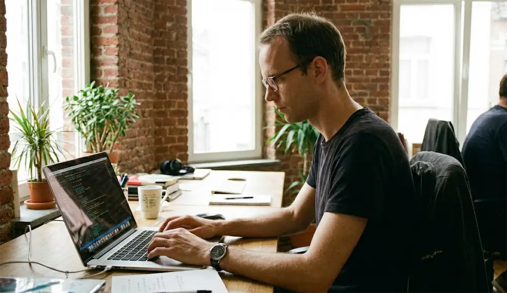 A developer at work in the agency office, in the years when the agency funded the development of Coddy.