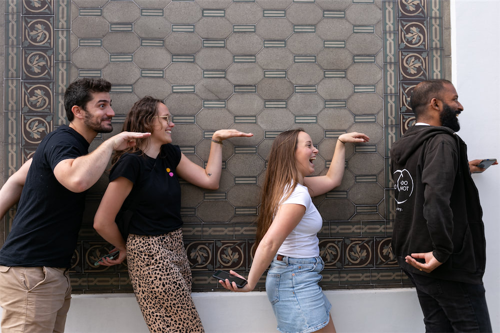 Friends playing Coddy in a European street, searching for clues