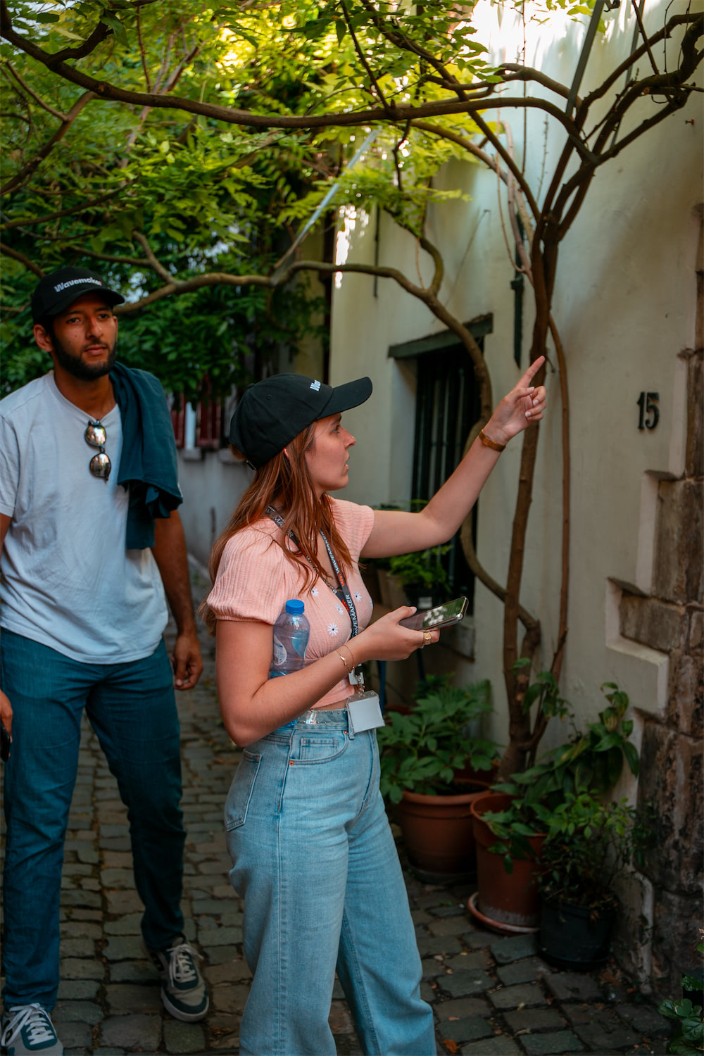 A family exploring the city with Coddy, kids pointing at a historic building